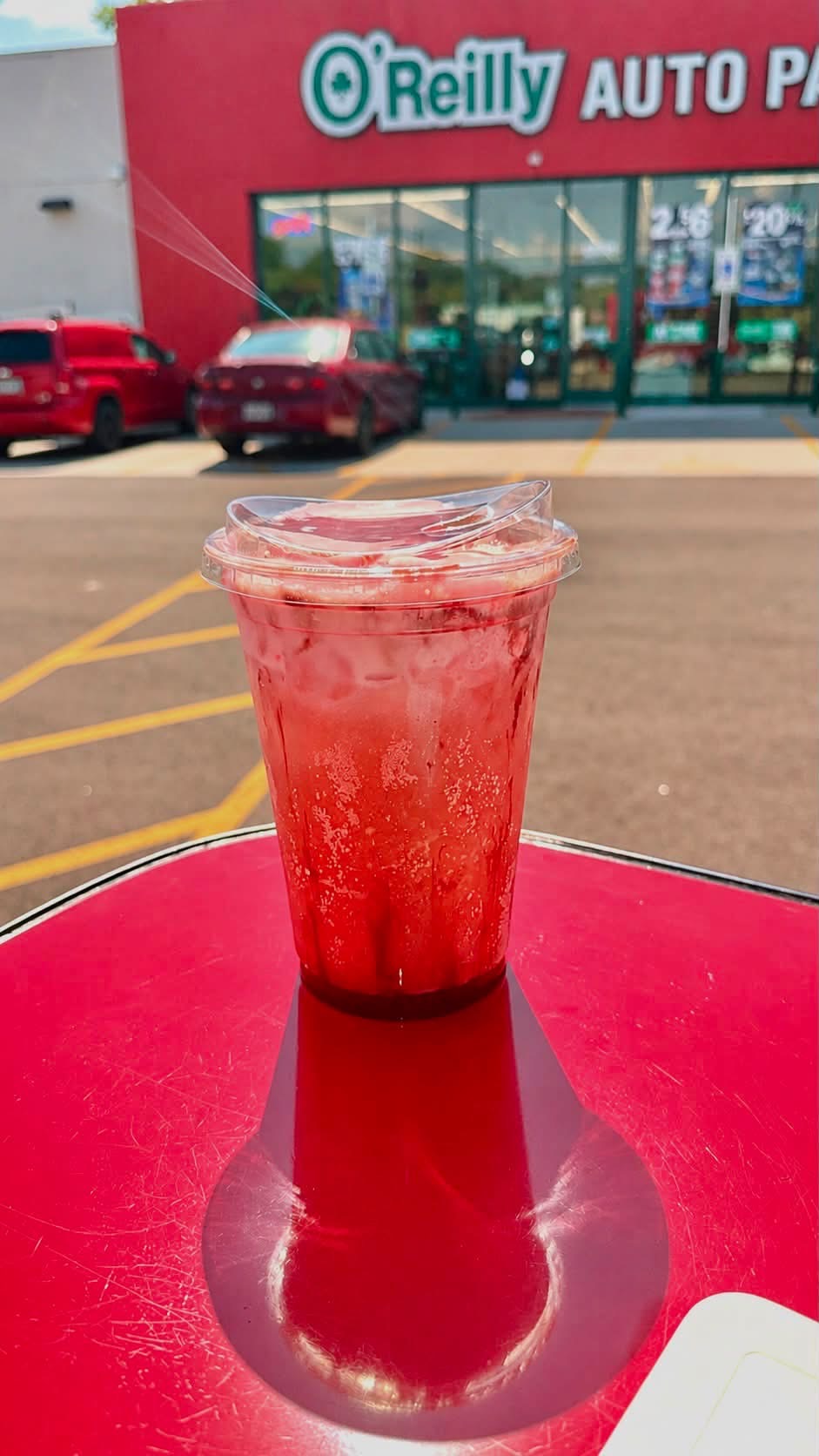 Bright red iced dirty soda with cream swirls