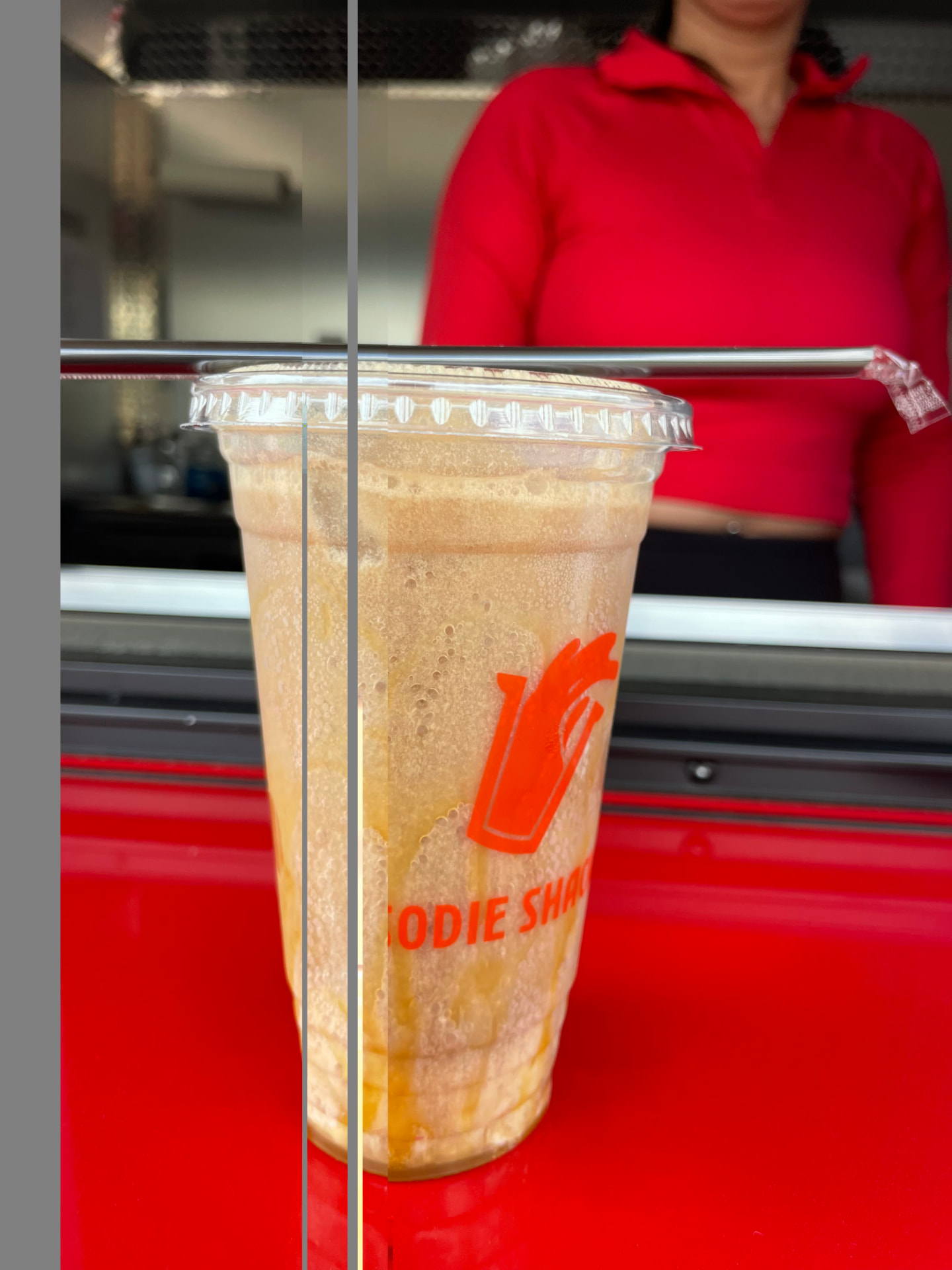 Iced soda with caramel drizzle and a straw